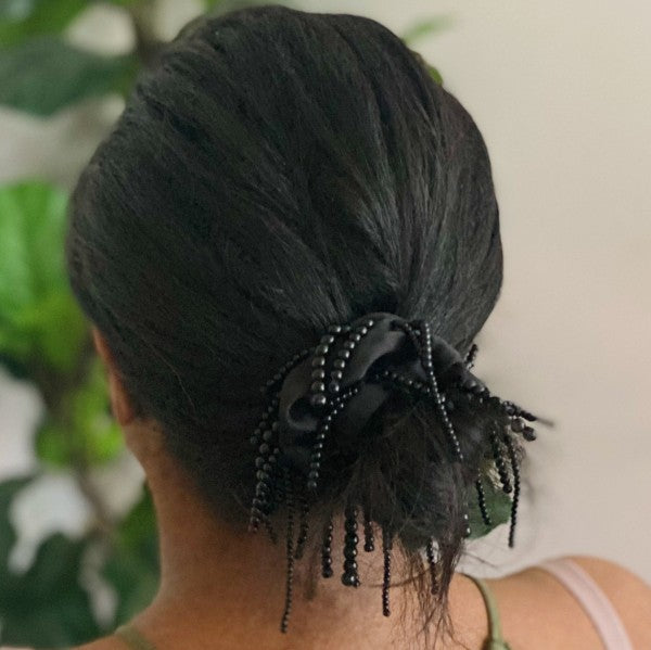 Elegant fringed hair scrunch with pearl details on model