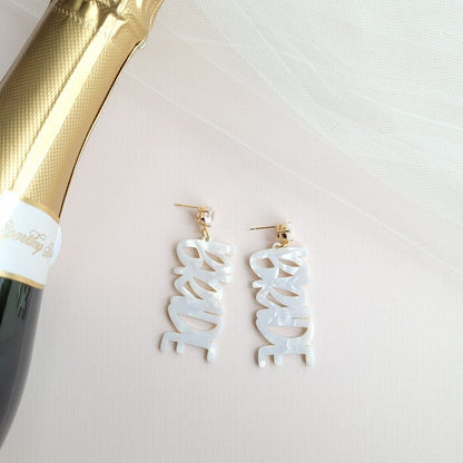 Gold bride earrings with hand-lettered calligraphy and zircon studs