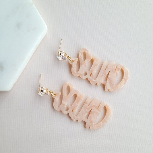 Gold bachelorette squad earrings with hand-lettered calligraphy