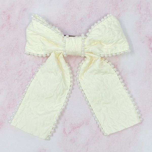 White pearl embellished bow barrette with elegant embossed fabric