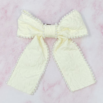 White pearl embellished bow barrette with elegant embossed fabric