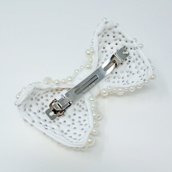 White pearl bow hair clip with elegant design for bridal hairstyles