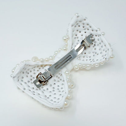 White pearl bow hair clip with elegant design for bridal hairstyles