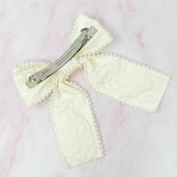 White pearl embellished bow barrette with elegant embossed fabric