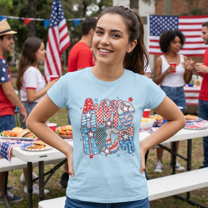 Woman wearing a 'America' t-shirt at a outdoor gathering with American flags.