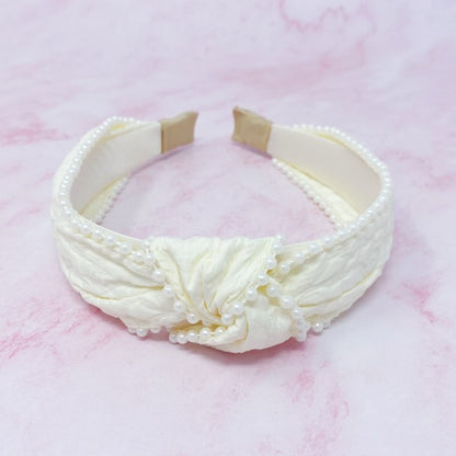 Knot pearl headband showing intricate embellishment details